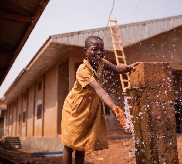 african-schoolchild-plays-splashing-water-from-the-2025-03-10-05-44-54-utc